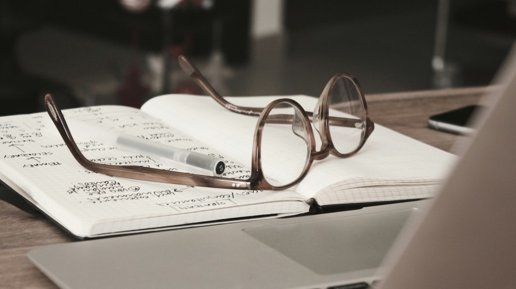 Image of glasses on notebook. Dan Dimmock, Unsplash